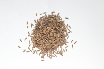 Pile of cumin seeds isolated on white background, top view