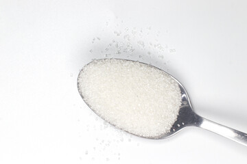 A spoonful of sugars on white background, top view