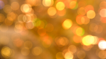 Obraz premium blurred bokeh light with yellow and orange colour christmas and party event background