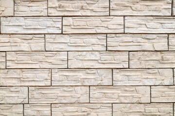 Wall made of artificial, decorative, painted stone.Brick wall for background.