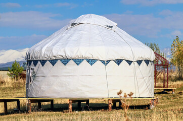 White yurt. Dwelling of nomads against the backdrop of mountains.