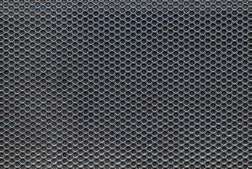 Black metal mesh as a background.Protection on the music column.