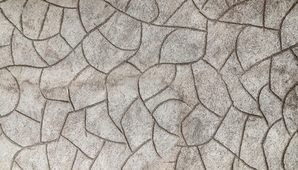 Rough cement plaster imitating stones on the wall close-up. High resolution photo.
