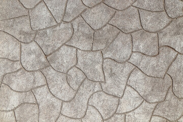 Rough cement plaster imitating stones on the wall close-up. High resolution photo.