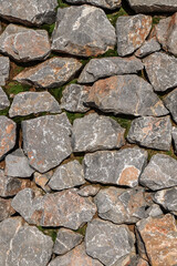 Stone wall. A fragment of a wall made of chipped stone. Background of old masonry. Stone wall texture