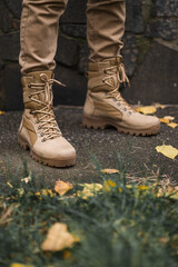 Leather waterproof boots on military. Demi-season high boots of khaki color