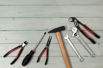 Set of working tools lying on white painted boards. View from above.