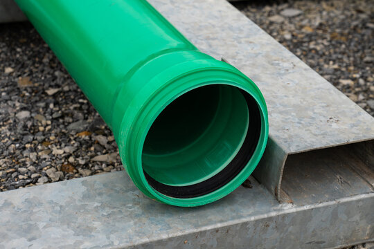 Part Of Green Plastic Pipe With A Connecting Flange At The End. Close-up.