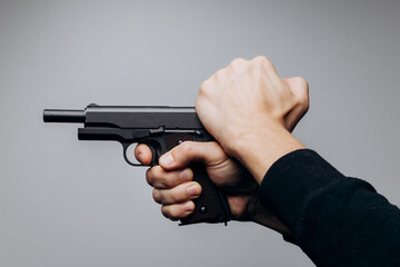 Close up of man hands with aiming gun on white background.