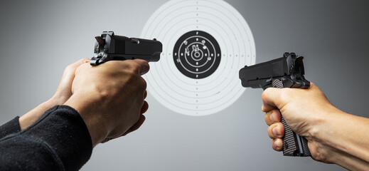 Hands with gun shooting target
