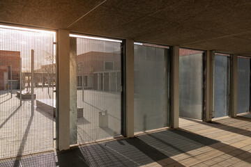 An interior shot of a building with sun shining on the background