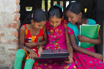 School Students Girls using laptop while studying at home - obrazy, fototapety, plakaty