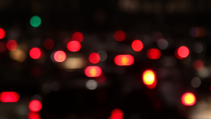 Blurred defocused image of evening car traffic in a big city. Cars in motion and standing in traffic jams. Long exposure exposure and headlight trails