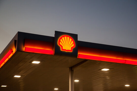 Irving, Texas, USA - March 20, 2022: A Shell gas station at dusk.  Shell Oil Company is an affiliate of the Royal Dutch Shell plc, a global group of energy and petrochemical companies. 