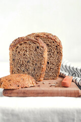 Fresh sourdouhg rye bread with sunflower seeds and flax on a wooden board. Copy space.
