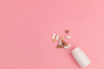 Medicine with pills on pink background