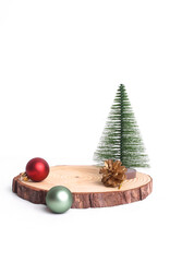 Merry Christmas mock up setups on white background. Xmas tree, jingle bells, wooden slice disc.