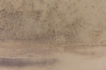 Sandy shore of the lake. Coastline of the lake. Close-up