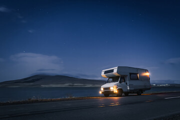 motorhome by the road at night hills and nature