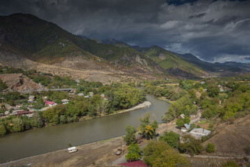 landscape on the river and the village in the mountains
