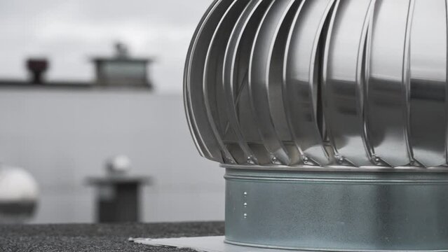 Rotary deflector on the apartment house rooftop.