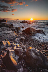 rocky coast of the black sea at sunset