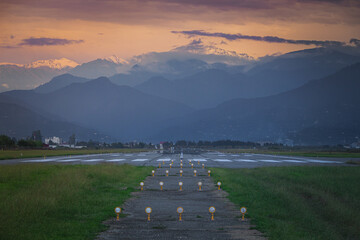 empty runway at sunset, mountains in the background