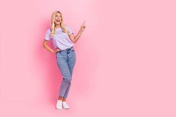 Full body photo of positive lady look direct finger empty space advert isolated on pink color background