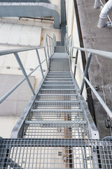 Obraz premium View of the galvanized stairs leading down to the roof.