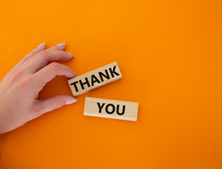 Start now symbol. Wooden blocks with words Start now. Beautiful orange background. Businessman hand. Business and Start now concept. Copy space.
