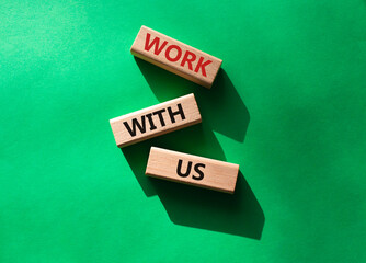 Work with us symbol. Wooden blocks with words Work with us. Beautiful green background. Business and Work with us concept. Copy space.