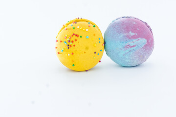 Sweet colorful macarons isolated on white background. Tasty colourful macaroons. Two multi-colored blue and yellow macaroons. French pastry made from egg whites.