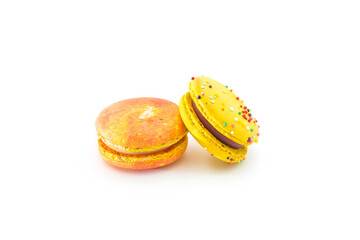 Sweet colorful yummy macarons isolated on white background. Tasty colourful macaroons. Two multi-colored orange and yellow macaroons. French pastry made from egg whites.