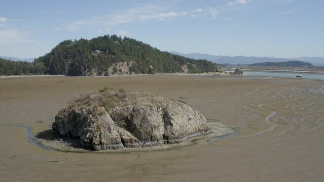 Orbital Shot of A Rock at Low Tide on Marthas Beach la Conner Washington USA - Mt Baker in the Background