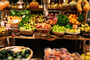 Farmer's market stall with a lot of vegetables and fruits. Local outdoor market on a sunny day.