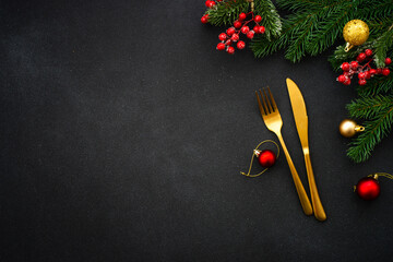 Christmas table setting with plate, cutlery and christmas decorations on white background.