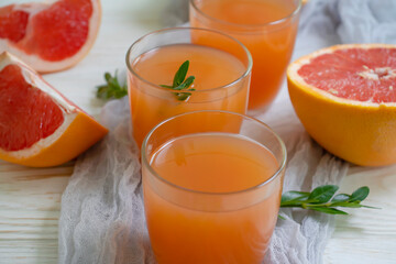 Fresh grapefruit juice on old background