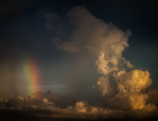 Fototapeta na wymiar Vertical rainbow within towering cumulus clouds over the Gulf of Mexico, Longboat Key, Sarasota, Florida