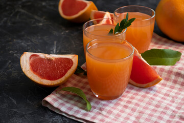 Fresh grapefruit juice on old background
