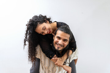 Portrait of a young hispanic couple Attractive latin man carrying his pretty girlfriend on the back