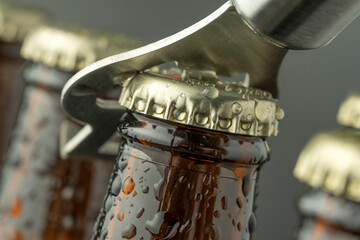 Cold beer in a brown bottle with large water drops on the glass surface. Dark craft beer