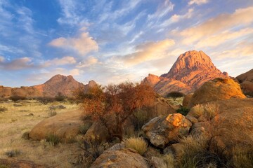 Sunrise in calm morning in Spitzkoppe, panoramic, desert landscape of famous red, granite rocks,...