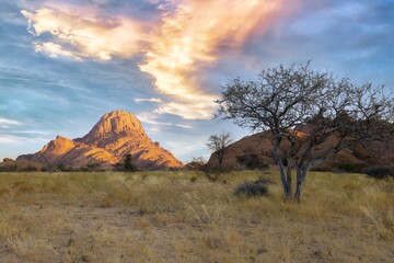 Naklejka premium Sunrise in calm morning in Spitzkoppe, panoramic, desert landscape of famous red, granite rocks, Namibia, Africa 