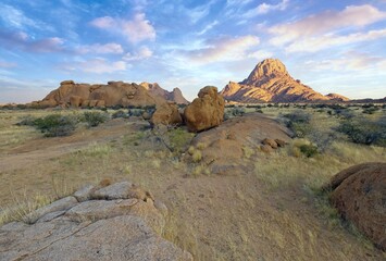 Sunrise in calm morning in Spitzkoppe, panoramic, desert landscape of famous red, granite rocks, Namibia, Africa 
