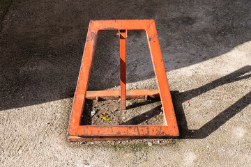 yellow metal fencing prohibiting entry to the parking space. yellow parking barrier on concrete. Mechanical barrier prohibiting the use of a parking space.