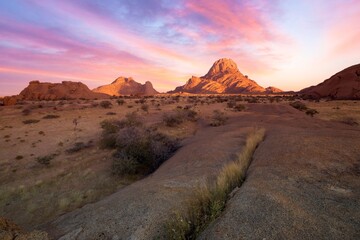 Sunrise in calm morning in Spitzkoppe, panoramic, desert landscape of famous red, granite rocks, Namibia, Africa 