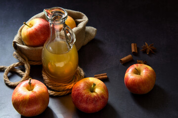 Apple juice with cinnamon in rustic composition.