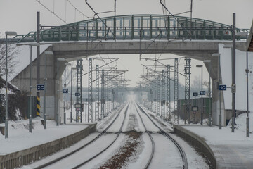 Veseli nad Luznici stop with snowy platforms and road bridge over railway