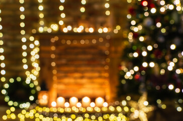 Abstract blurred photo of beautiful fireplace, wooden mantelpiece with fairy lights bokeh, hlit up...