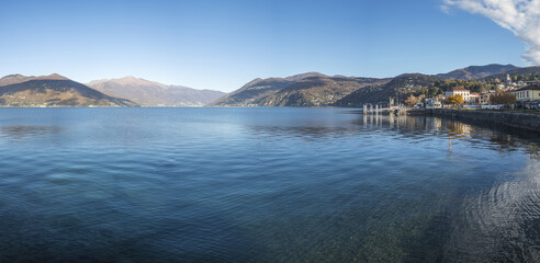 Extra wide angle view of The promenade on the lake in Luino with the mountains in the background